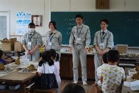 小学生の作陶のお手伝いをしている様子1枚目